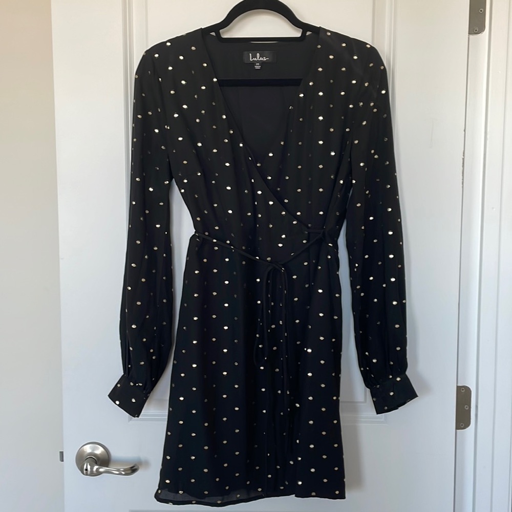 Short black wrap dress with gold polka dots